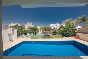 Garden with barbecue, dining area, lawn, sunloungers and private pool