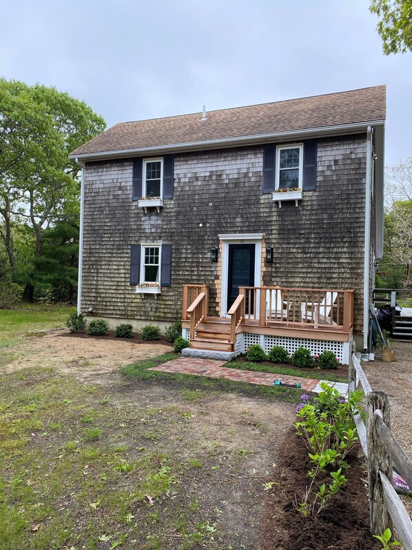 Classic Edgartown salt box with peaceful sitting deck for relaxing.