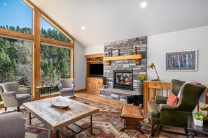 Relax with family and friends in front of fireplace.