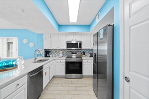 Kitchen - Bright and airy view of the Kitchen enhanced by the Stainless Steel appliances makes meal prepping effortless.