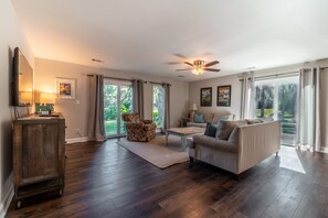 Family room with golf and lagoon views and slider leading to deck