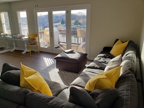 Main Level Living Room, and Large Windows Open Up to Deck