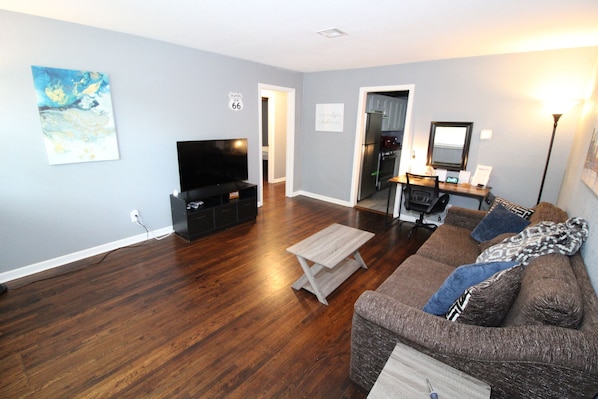 Living room with large comfy couch and smart TV with game system