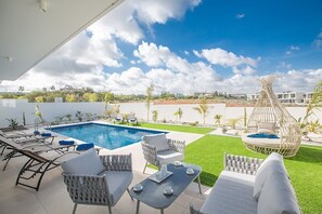 Garden with barbecue, seating area, dining area, shower, sunloungers and pool