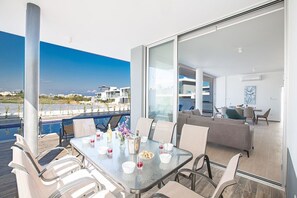 Shaded outside dining area with table and chairs to seat 8 people
