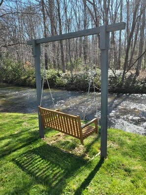 Enjoy the meditative sounds of the creek while sitting on this swing.