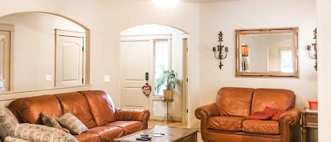 This cozy living room is comfortable to sip on hot chocolate by the fireplace. 
