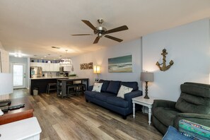 The kitchen, dining, and living areas blend seamlessly for a bright and airy feel