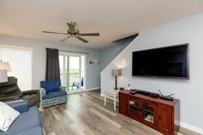 Access to outdoor balcony with a beach view from the living area