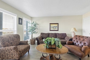 Unwind in the living area with cozy furniture with natural light shinning in