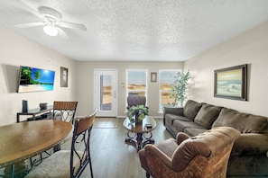 Living area with queen size sleeper sofa and a lovely view of the dunes and partial beach