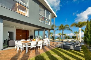 Outside dining area with table and chairs to seat 10 people