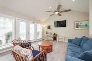 Charming living area with flat screen TV and lots of natural lighting