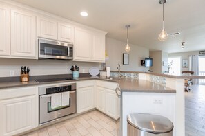 Fully equipped kitchen with updated appliances, plenty of counter space and open concept layout