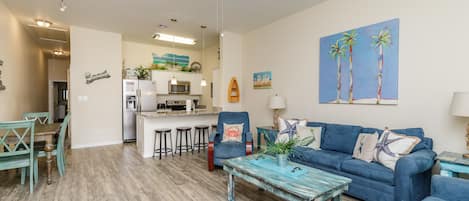 Updated living and kitchen area with coastal vibes and new décor throughout