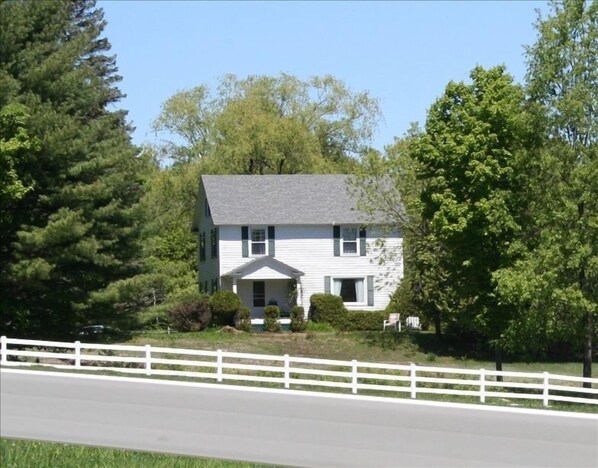 View of house from the road leading into the property by the horse pasture