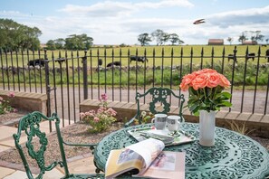 Farm Cottage - enjoy a cup of tea in the front patio garden, whether basking in the summer sun, wrapped up on a crisp autumn morning, under the gentle warmth of spring, or watching winterâ€™s frost glisten