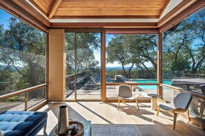 Haven is special for its large indoor and outdoor communal spaces. Two-level living room with a 80" 4k TV sits next to the kitchen and dining room. Both rooms open to the back deck with the pool, hot tub, and outdoor dining.