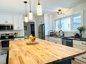 Spacious and fully equipped kitchen with large butcher block island.