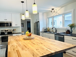 Spacious and fully equipped kitchen with large butcher block island.