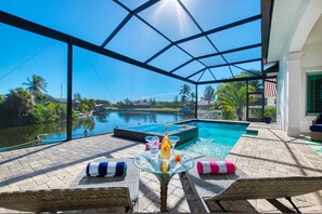 Pool and hot tub with lounge chairs
