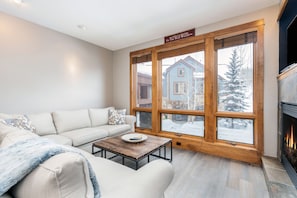 Living room with wood-framed window and snowy background