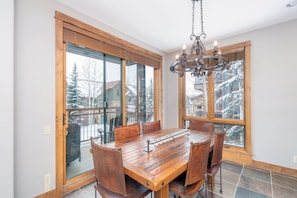 Dining room with wood furniture and snowy views