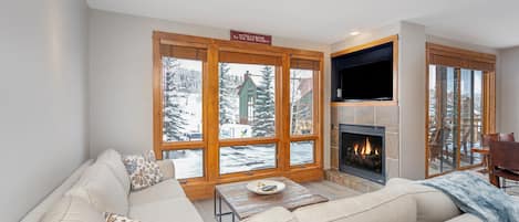 Living room with white couch and wood window