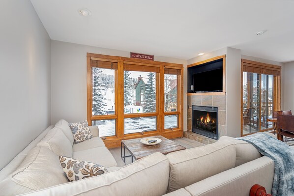 Living room with white couch and wood window