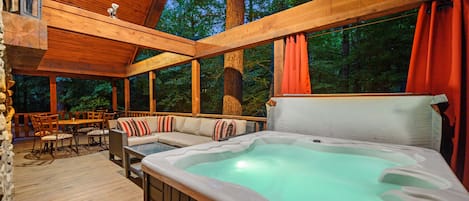 Relax in the hot tub overlooking fireplace on large covered porch