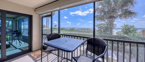 Screened in patio with table and 4 chairs, storage closet w/beach supplies.