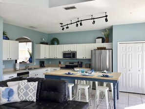 Eat-in kitchen with updated appliances that opens to the family room and pool.