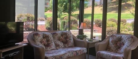 Sunroom with tv and seating area
