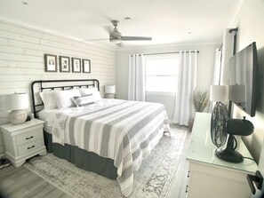 The master bedroom has a king sized bed and a great view of the ocean. You can step outside to the balcony too.