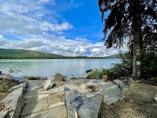 Beautiful private stone patio, fire pit and walk way to the waters edge, fire pit and dock.