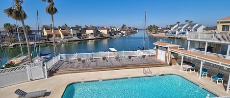 View from our patio overlooking our outside pool and wide canal to Gulf Bay.