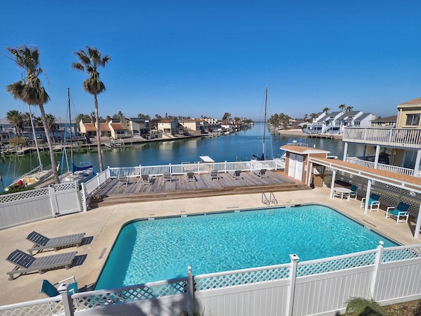 View from our patio overlooking our outside pool and wide canal to Gulf Bay.