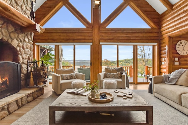 The great room boasts an amazing view of the property with a large fireplace