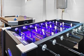 We have LED light up glow in the dark Air Hockey and Foosball Tables! Free Play!