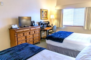 Guest bedroom with desk for working guests, Keurig coffee maker and flat screen TV