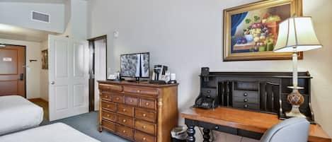 Guest bedroom with desk for working guests, Keurig coffee maker and flat screen TV