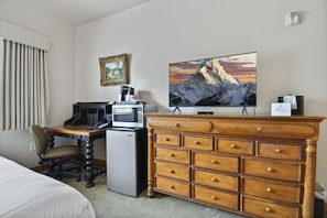 Guest bedroom offers flat screen TV,  mini refrigerator, microwave,  Keurig,  and desk space perfect for the guest who works during their trip.