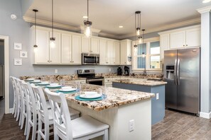 Modern kitchen with granite countertops, stainless steel appliances, and a large island—perfect for cooking and entertaining