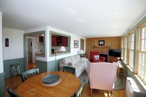 Dining area and living room with kitchen beyond
