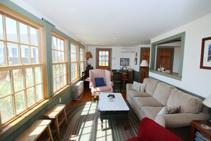 Living room with views has comfortable seating and flat screen TV