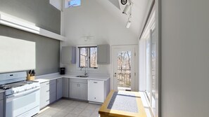 Open and bright kitchen has skylights and vaulted ceiling