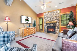 Living Room featuring Deck Access, Seasonal Gas Fireplace, Cable TV/DVD, and a Sofa Bed