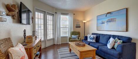 Open living area with plenty of comfy seating and bright light shinning in