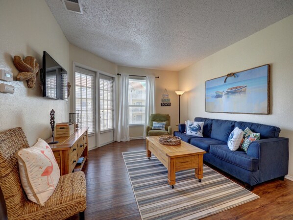 Open living area with plenty of comfy seating and bright light shinning in