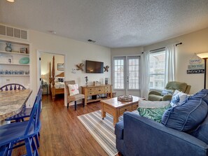 Spacious living area with natural light shinning in